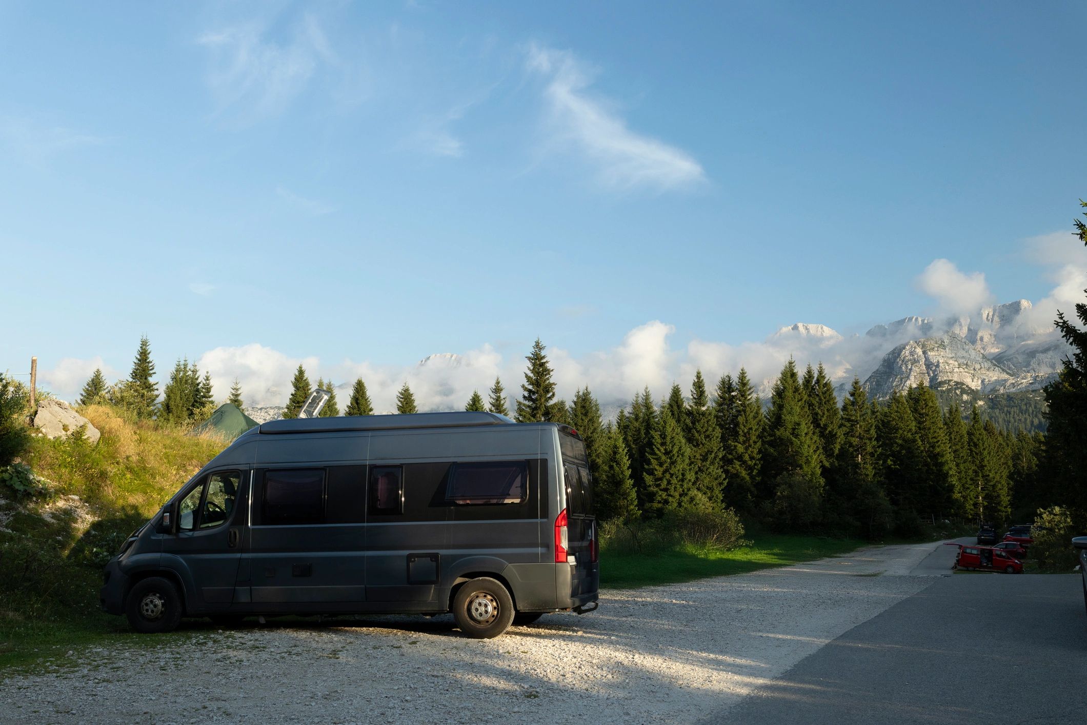 Motorhome parked in a mountain forest setting